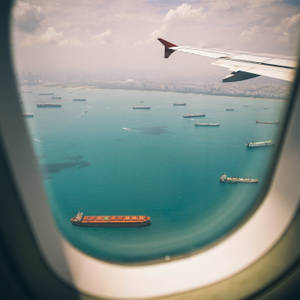 Airplane Window Travel Ocean View Wallpaper