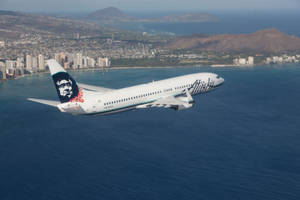 Alaska Airlines Flying Above The Ocean Wallpaper