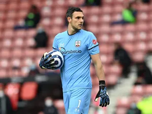 Alex Mccarthy Walking While Holding A Ball Wallpaper