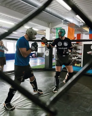 Alexander Volkov Posing Behind A Grate Railing Wallpaper