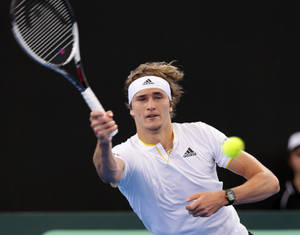 Alexander Zverev Delivers A Forehand Volley On Court Wallpaper