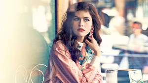 Alexandra Daddario 4k In A Cafe Wallpaper