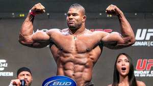 Alistair Overeem, Showing Off His Biceps With A Powerful Flex. Wallpaper