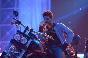 Allu Arjun Hd Motorcycle On Stage Wallpaper