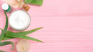 Aloe Vera Cream On Pink Table Wallpaper