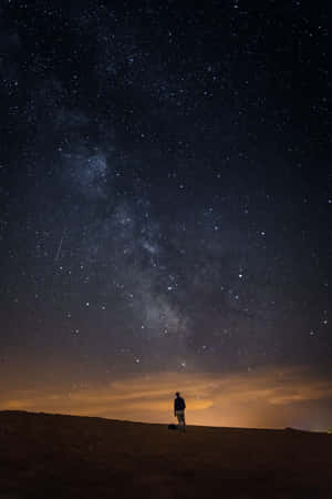 Alone Man In A Dark Starry Night Wallpaper