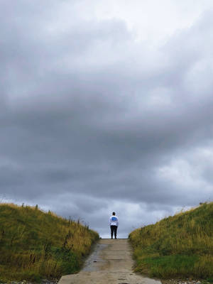 Alone Man Over Storm Clouds Wallpaper