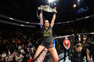 Amanda Nunes Raising Championship Belt Wallpaper