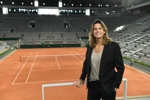 Amélie Mauresmo Posing Near Tennis Court Wallpaper