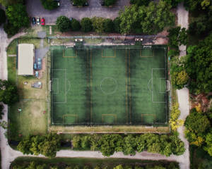An Aerial View Of A Soccer Field, Showing Expansive Green Grass And White Lines Of A Freshly Marked Pitch. Wallpaper