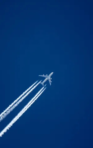 An Aeroplane Mesmerizingly Capturing The Sunset Sky Wallpaper