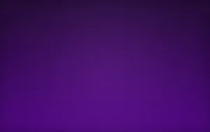 An Aesthetically Pleasing Home Office Setup Featuring A Purple Desktop Wallpaper