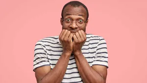 An Anxious Man Biting His Nails Wallpaper