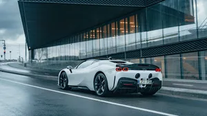 An Iconic Ferrari Spotted Driving Along The Street Wallpaper