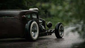 An Old Fashioned Car Is Parked On A Road Wallpaper