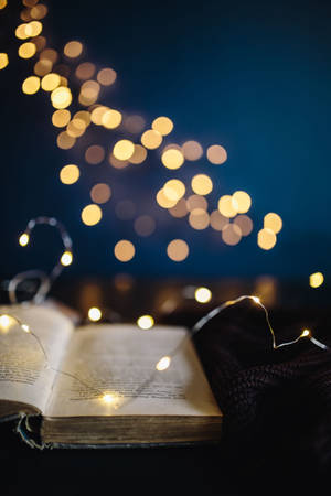 An Open Book With Lights On It Wallpaper