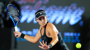 Anett Kontaveit Swinging A Blue Racket Wallpaper