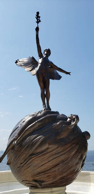 Angel Statue Holding A Flower Wallpaper