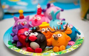 Animal Cartoon Clay Figurines On Plate Wallpaper