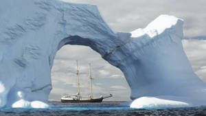 Antarctica Arch Glacier And Ship Wallpaper