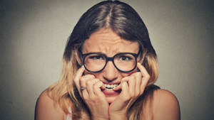 Anxious Woman With Eyeglasses Wallpaper