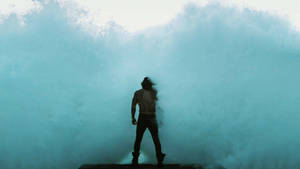 Aquaman Standing Against Waves Wallpaper