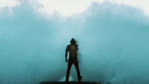 Aquaman Standing Against Waves Wallpaper