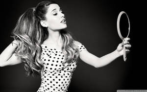 Ariana Grande Embracing Her Beauty In A Hand Mirror Wallpaper