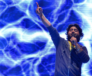Arijit Singh Performing On Stage Wallpaper