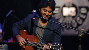 Arijit Singh Playing Guitar On Stage Wallpaper