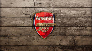 Arsenal Emblem On Wood Floor Wallpaper