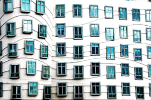 Artistic Contrast Of Dancing House’s Architecture Wallpaper