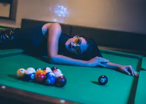 Artistic Image Of A Woman Lounging On A Pool Table Wallpaper