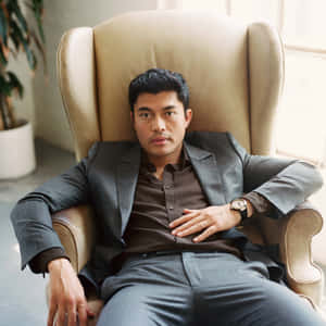 Asian Actor On The Chair Wallpaper