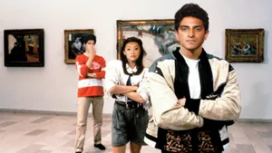 Asian Woman Appreciating Art In A Museum. Wallpaper