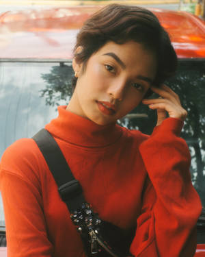 Asian Woman In Stylish Red Turtleneck Wallpaper