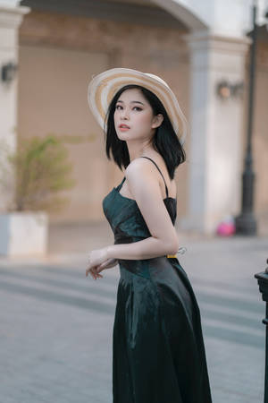 Asian Woman Wearing Elegant Green Dress Wallpaper