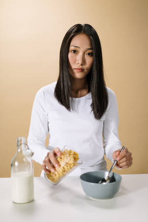 Asian Woman With Milk And Cereal Wallpaper