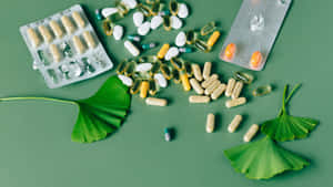 Assorted Medicationsand Supplementson Green Background Wallpaper