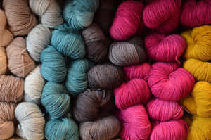 Assorted Multi-colored Knitworks And Varied Knitting Yarns Wallpaper