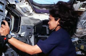 Astronaut_at_ Space_ Shuttle_ Controls Wallpaper