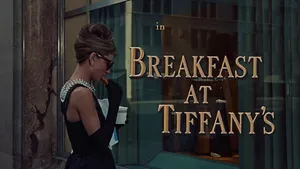 Audrey Hepburn Outside Of Tiffany's Jewelry Looking Beautiful In Her Signature Style Wallpaper