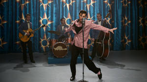 Austin Butler Showcasing His Talent While Performing As Elvis Presley Wallpaper