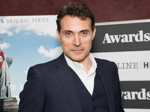 Award Winning Actor Rufus Sewell In A Stylish Suit Wallpaper