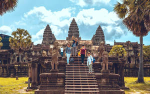 Awe-inspiring Angkor Wat: Tourists Among Ancient Ruins. Wallpaper