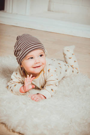 Baby Boy Smiling And Waving Wallpaper