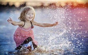 Baby Girl Playing Water Wallpaper