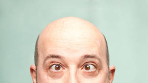 Bald Man With Crossed Eyes Wallpaper