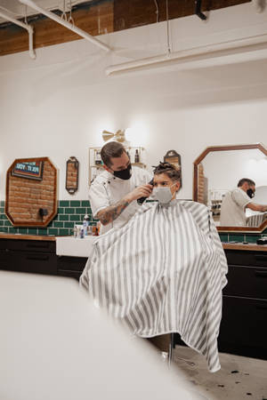 Barber Doing Haircut On Client Wallpaper