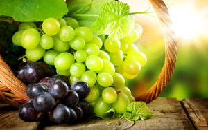 Basket Of Green And Purple Grapes Wallpaper